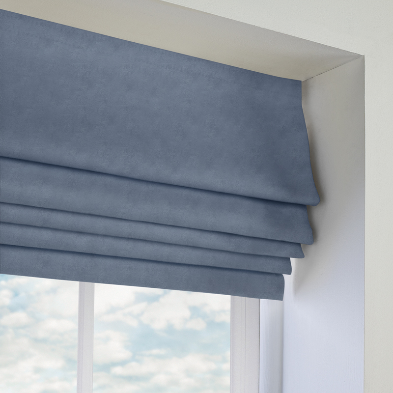 blue roman blinds in window frame