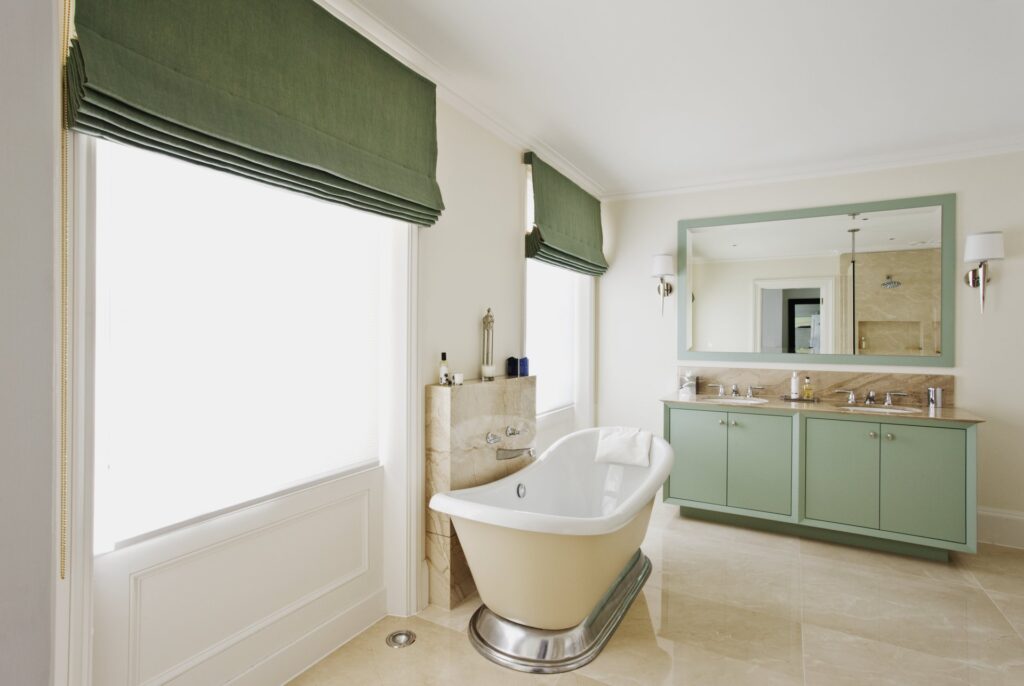 green roman blinds in bathroom window