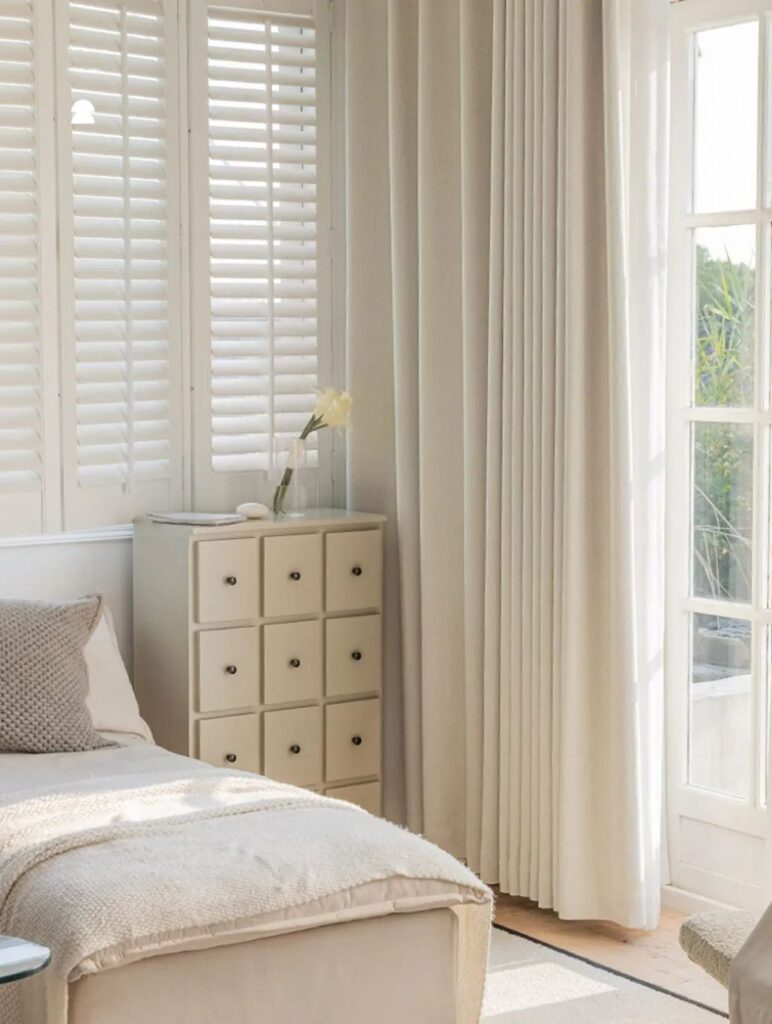 cream off white curtain over french door in bedroom